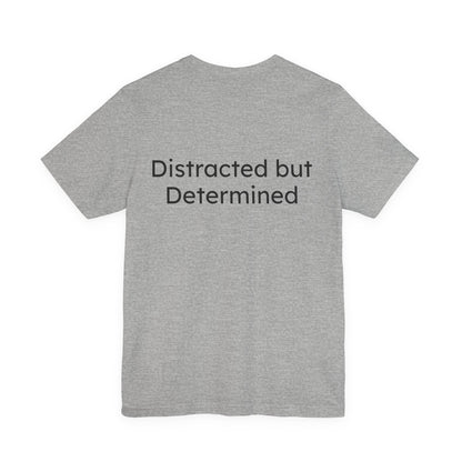 Gray t-shirt with 'Distracted but Determined' text on the back against a white background