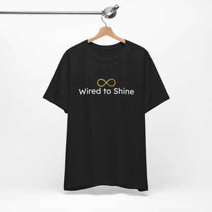 Black t-shirt with 'Wired to Shine' text and infinity symbol on a hanger against a white background