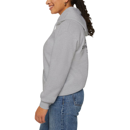 Person wearing a gray hoodie with text on the sleeve against a white background