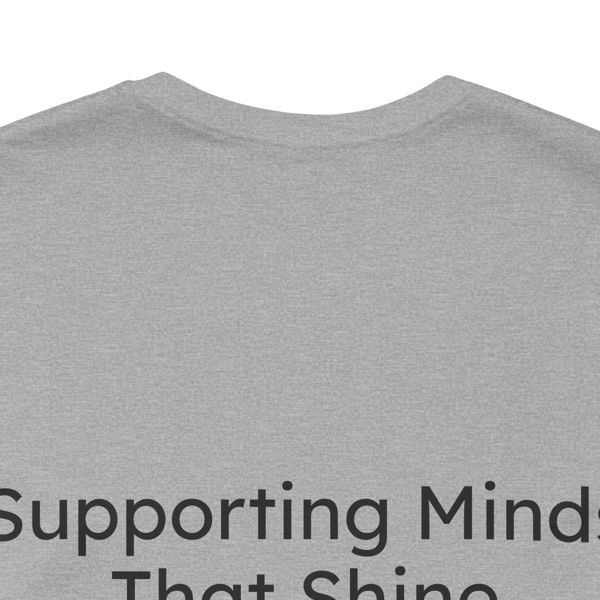 Gray t-shirt with text 'Supporting Minds That Shine' on a white background