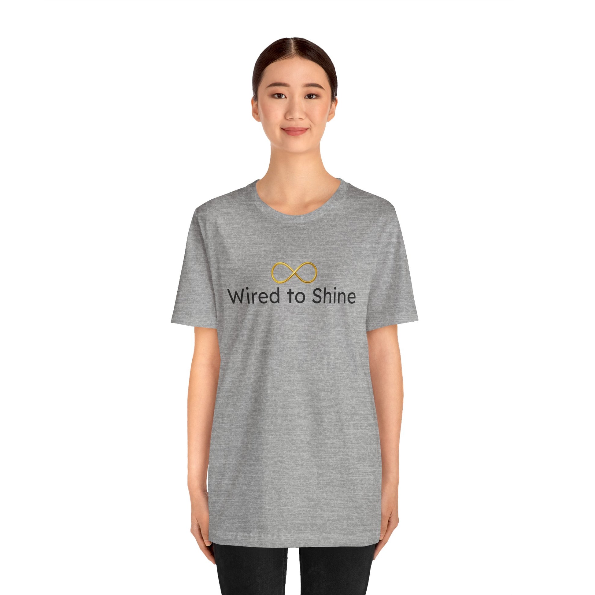 Person wearing a gray t-shirt with 'Wired to Shine' text and logo on a white background
