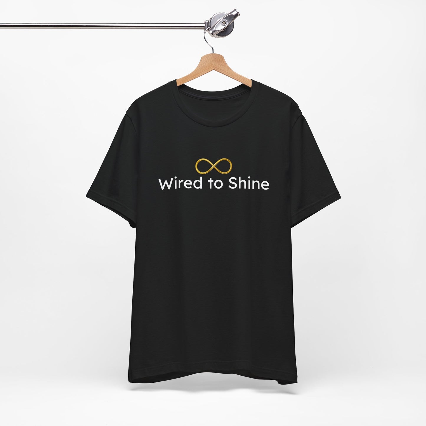 Black t-shirt with 'Wired to Shine' text and infinity symbol on a hanger against a white background