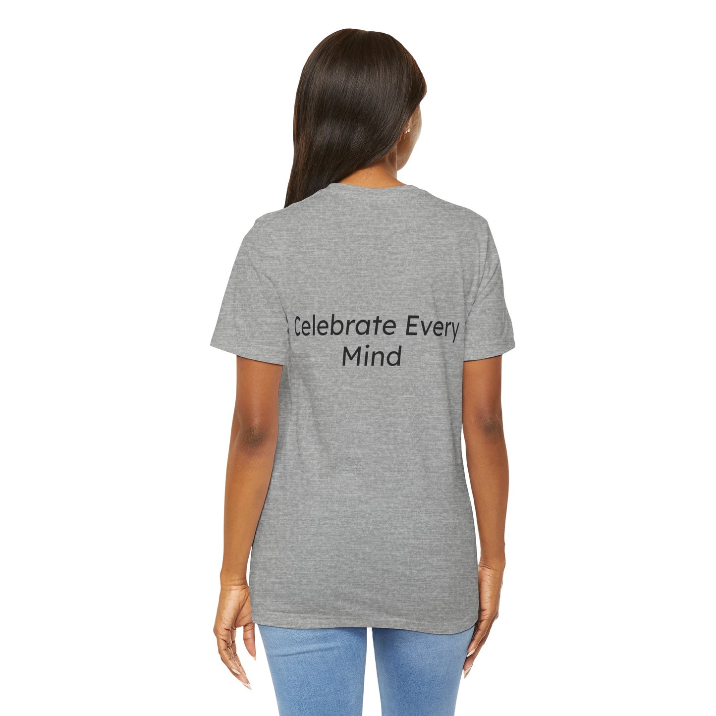 Person wearing a gray t-shirt with 'Celebrate Every Mind' text on the back, standing against a white background.