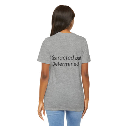 Person wearing a gray t-shirt with 'Distracted but Determined' text on the back.