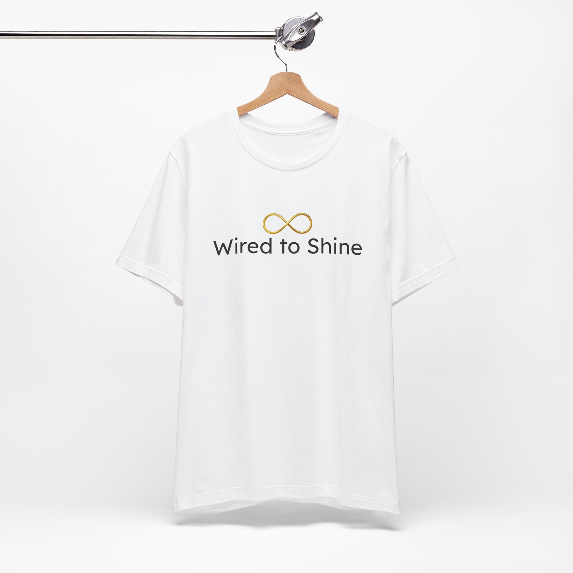 White t-shirt with 'Wired to Shine' text on a hanger against a white background