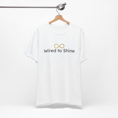 White t-shirt with 'Wired to Shine' text on a hanger against a white background