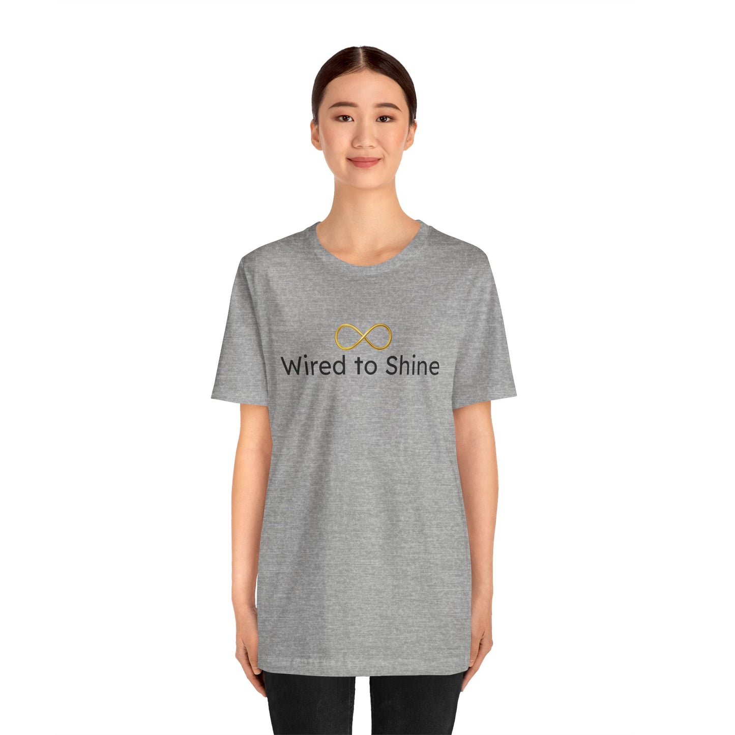 Person wearing a gray t-shirt with 'Wired to Shine' text and logo on a white background