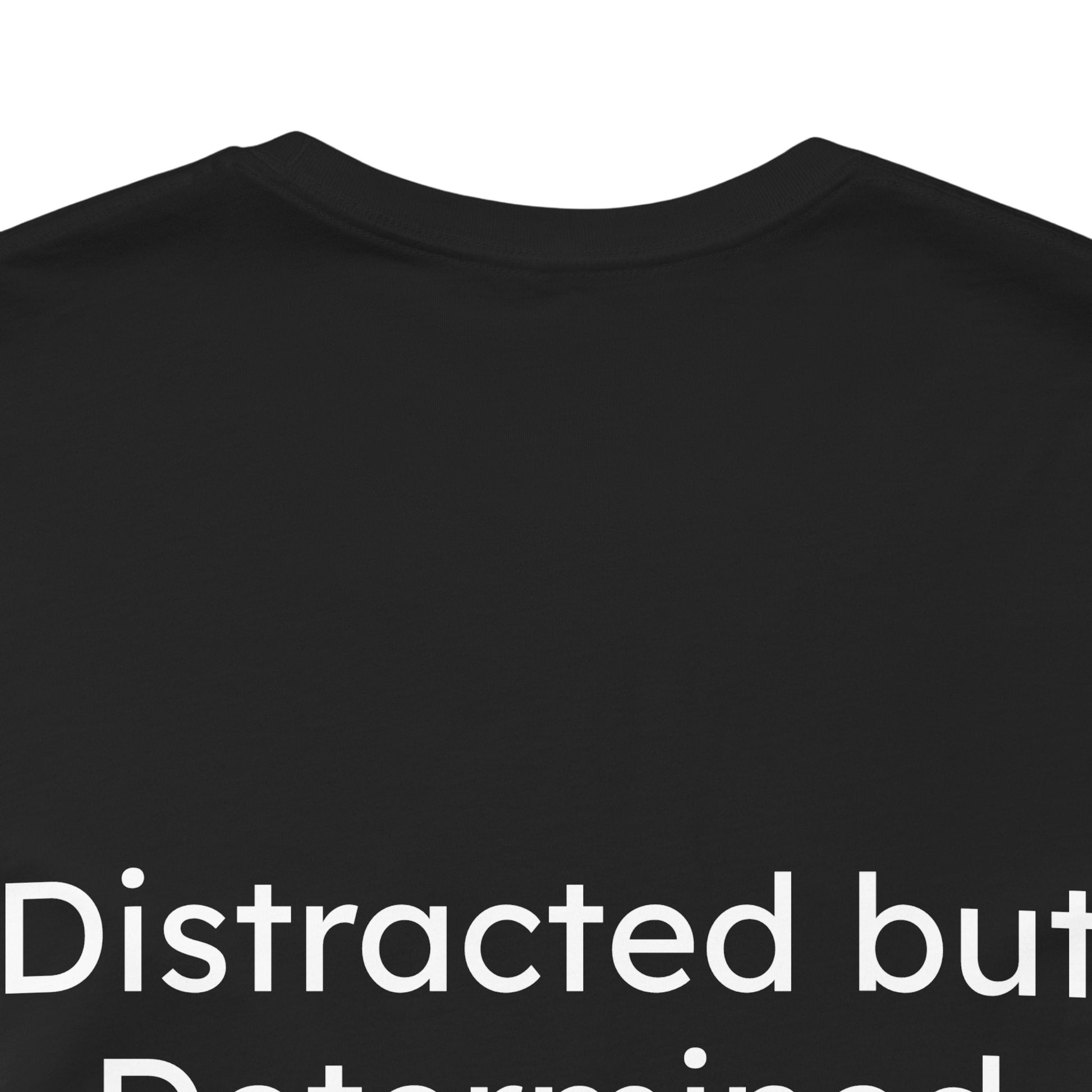 Black t-shirt with white text 'Distracted but Determined' on a white background