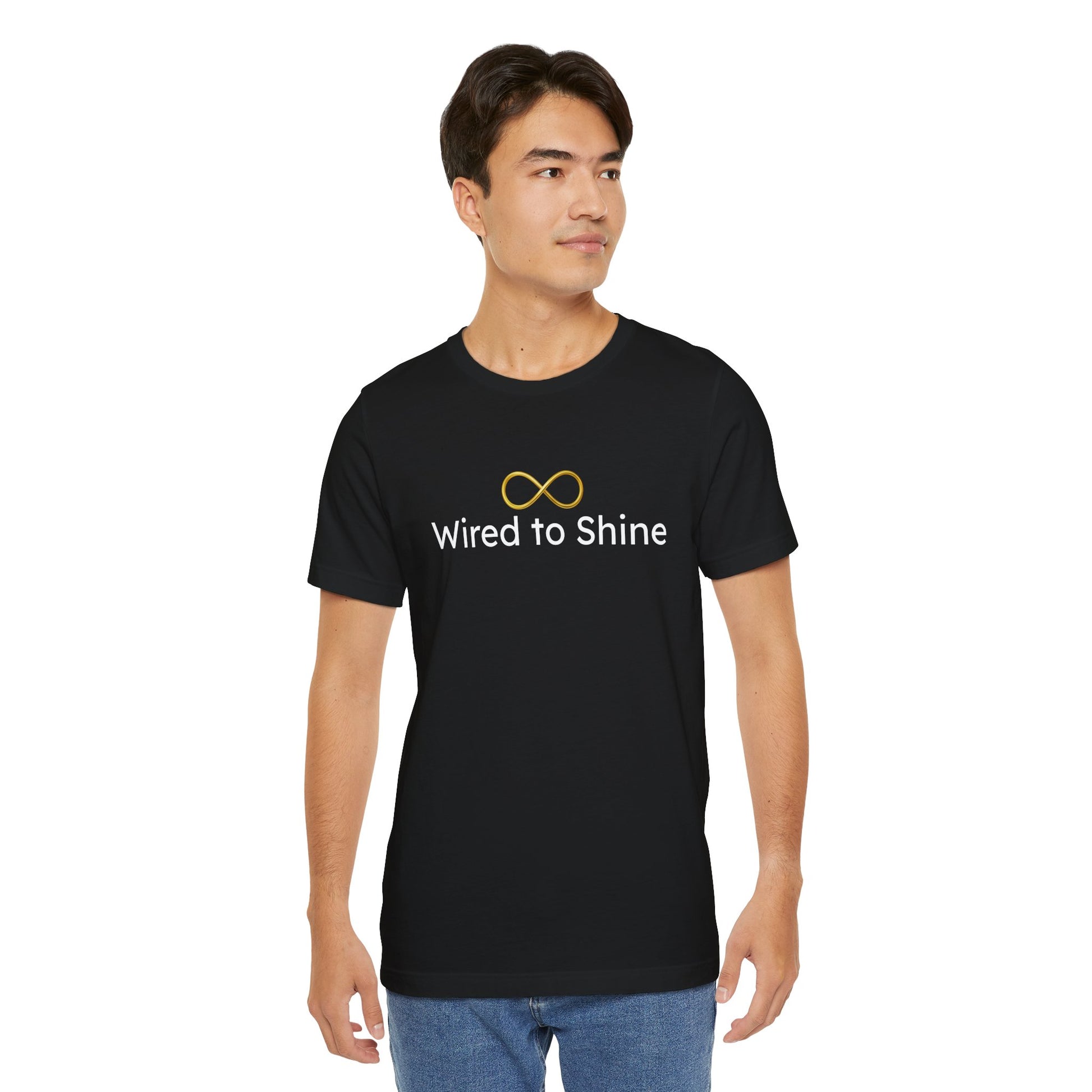 Man wearing a black t-shirt with 'Wired to Shine' text and infinity symbol on a white background