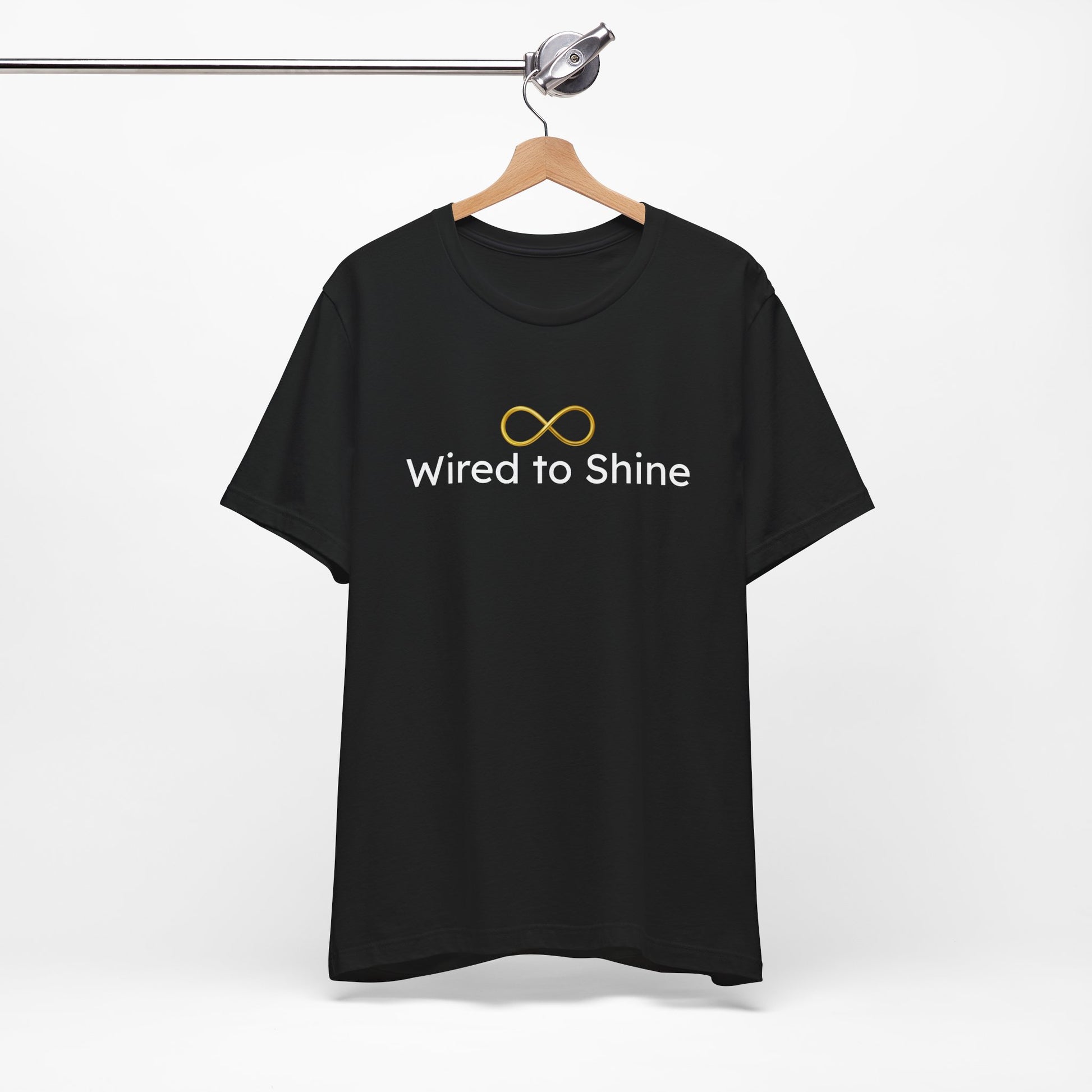 Black t-shirt with 'Wired to Shine' text and infinity symbol on a hanger against a white background