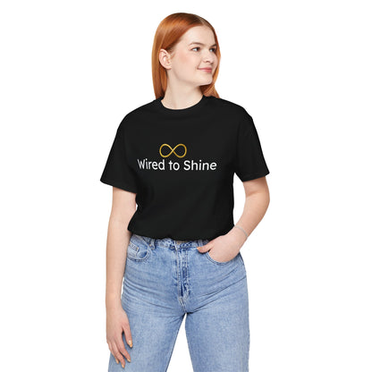 Person wearing a black t-shirt with 'Wired to Shine' text and infinity symbol on a white background