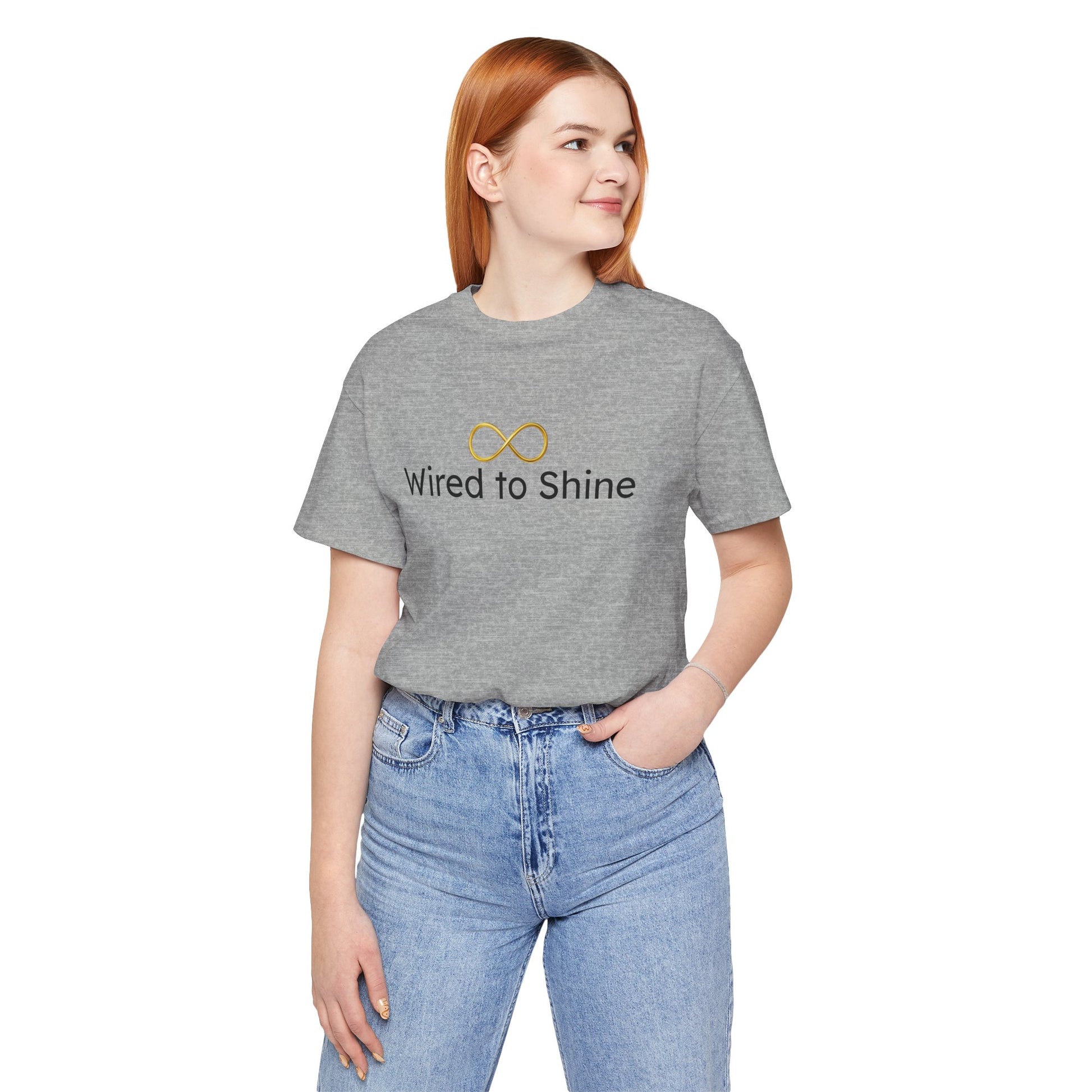 Person wearing a gray t-shirt with 'Wired to Shine' text and infinity symbol on a white background