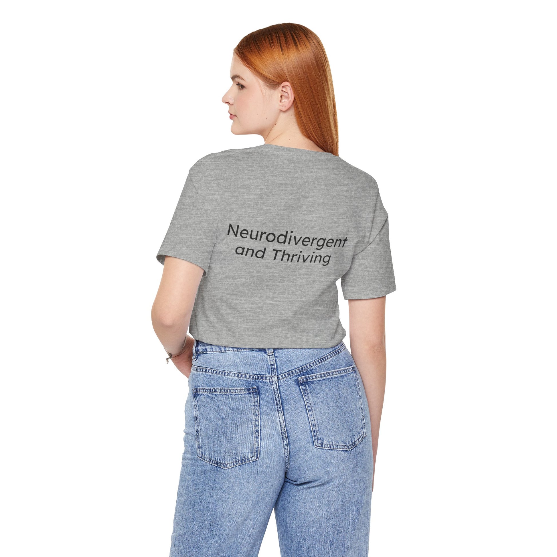 Person wearing a gray t-shirt with 'Neurodivergent and Thriving' text on the back, standing against a white background.
