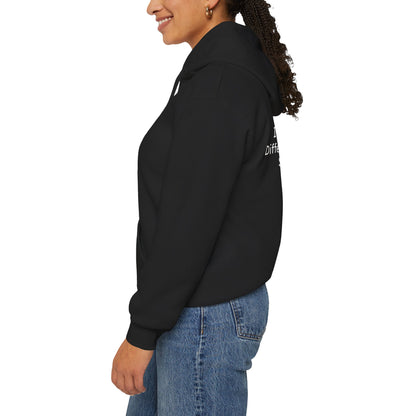 Person wearing a black hoodie with text on the sleeve against a white background