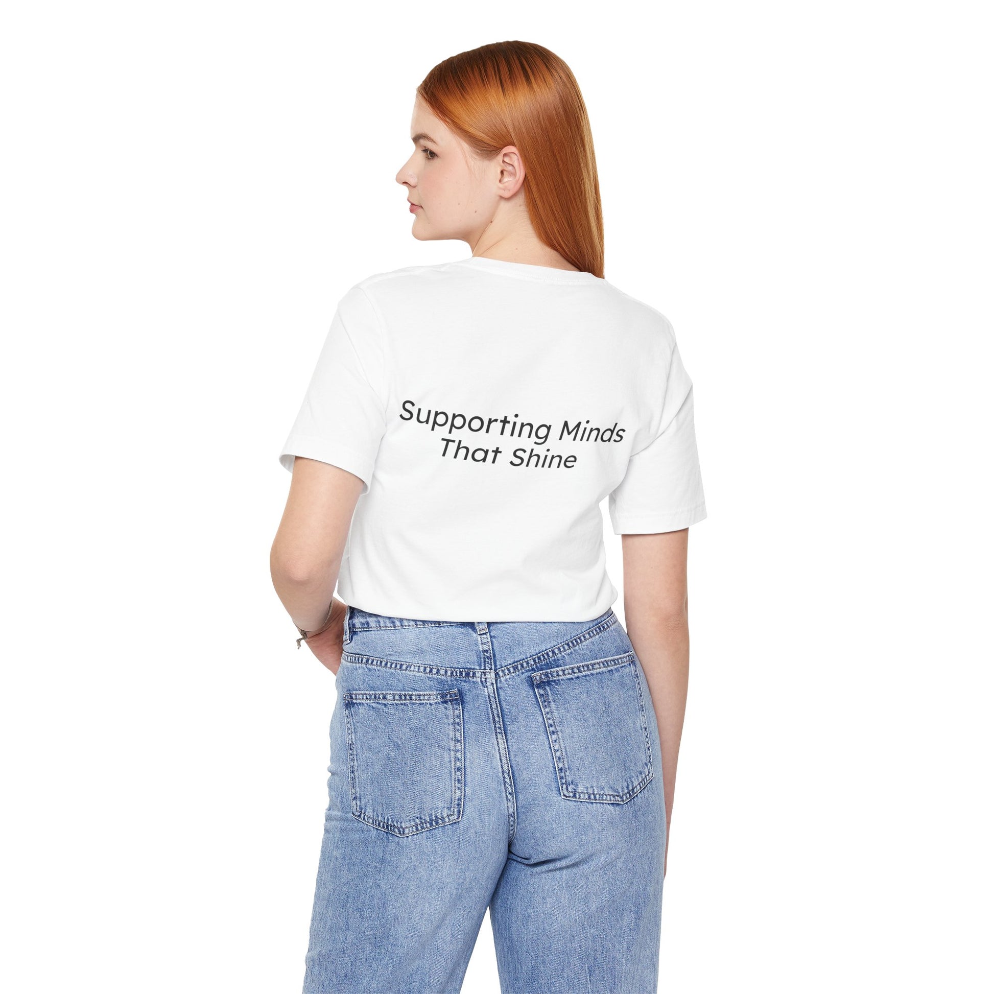Person wearing a white t-shirt with 'Supporting Minds That Shine' text on the back, standing against a white background.