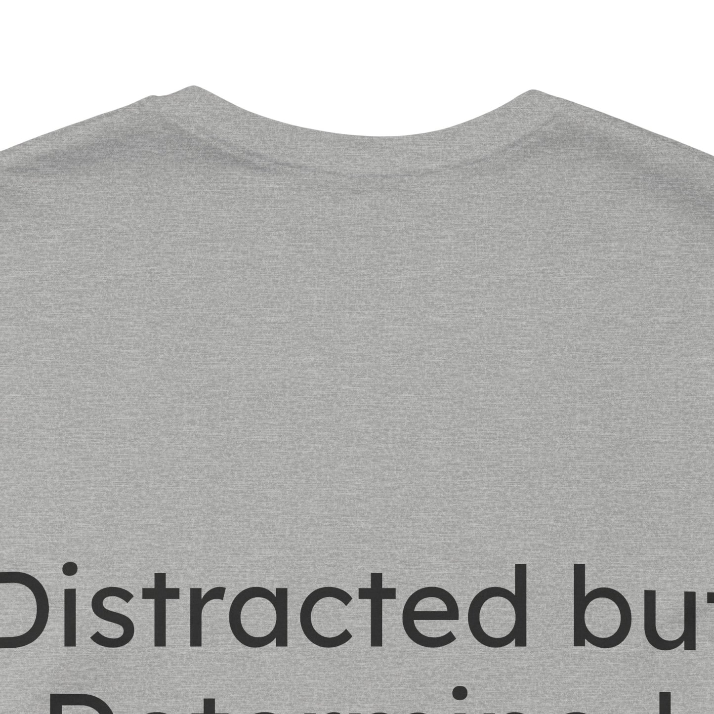 Gray t-shirt with text 'Distracted but Determined' on a white background