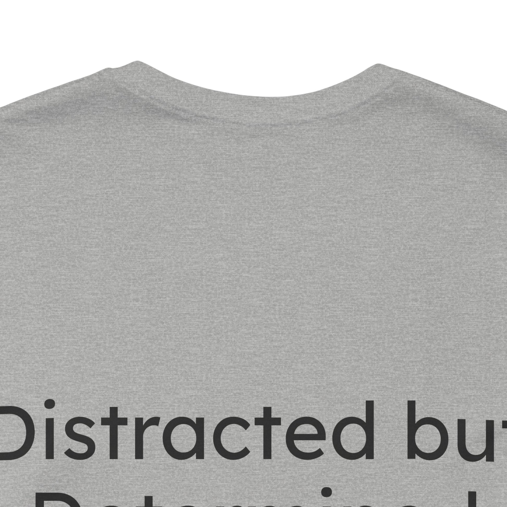 Gray t-shirt with text 'Distracted but Determined' on a white background