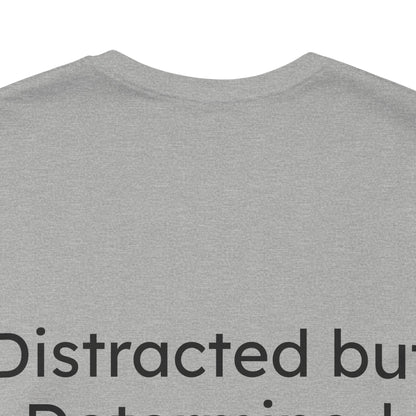 Gray t-shirt with text 'Distracted but Determined' on a white background