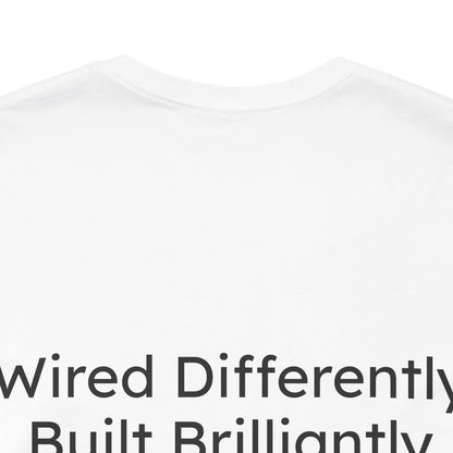 White t-shirt with text 'Wired Differently, Built Brilliantly' on a white background