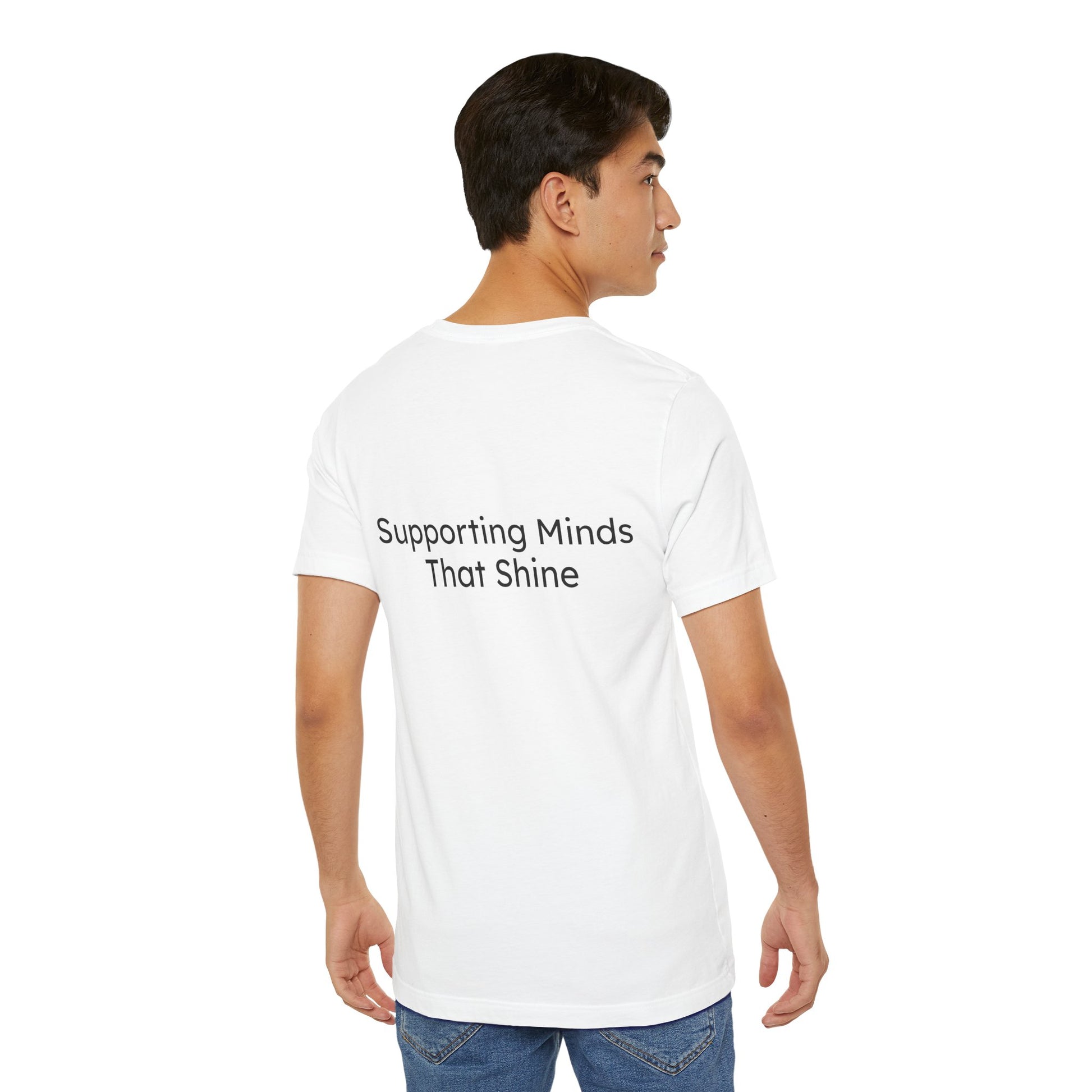 Person wearing a white t-shirt with 'Supporting Minds That Shine' text on the back, standing against a white background.
