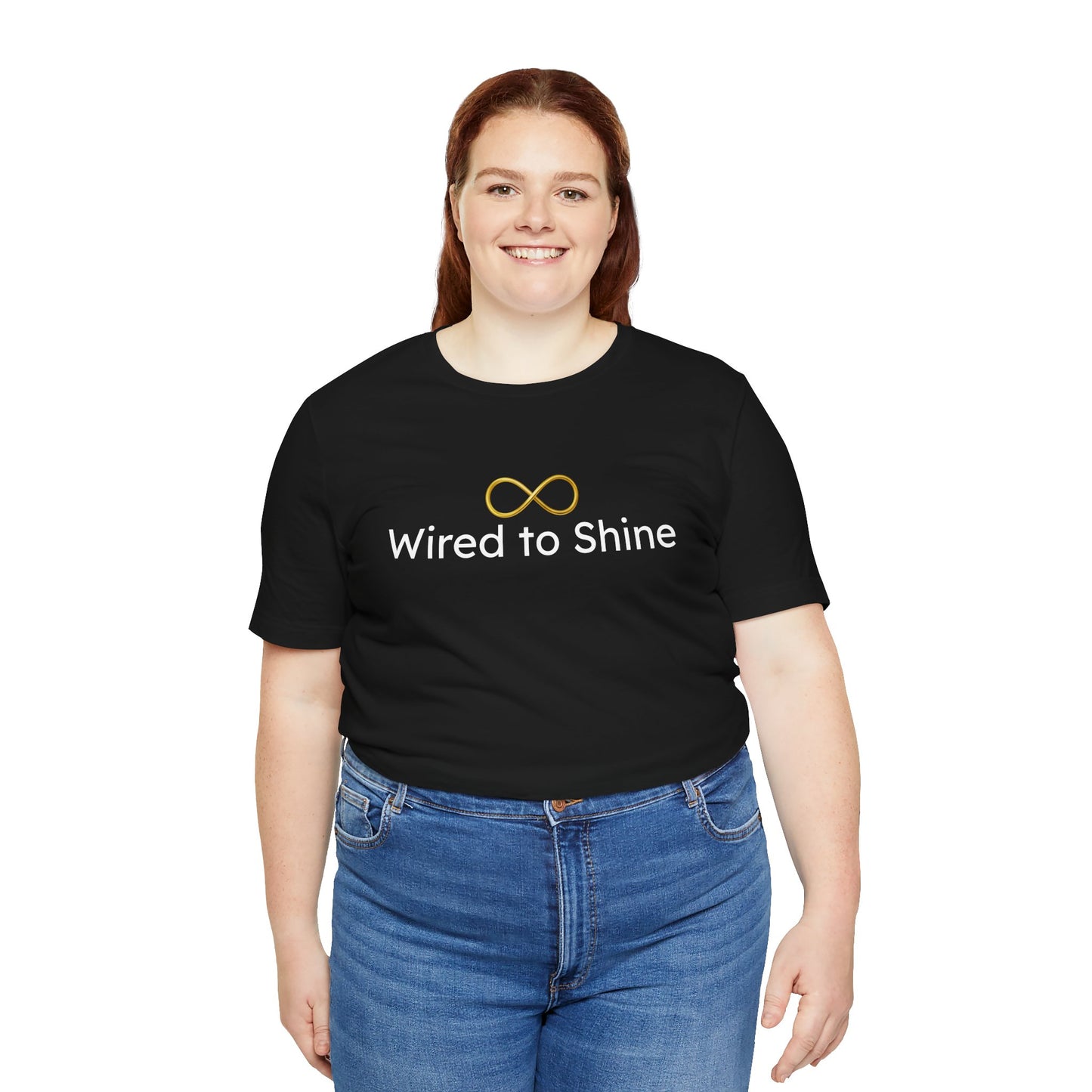 Person wearing a black t-shirt with 'Wired to Shine' text and blue jeans on a white background
