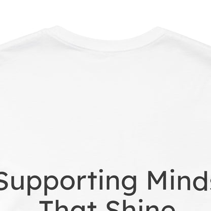 White t-shirt with text 'Supporting Minds That Shine' on a white background