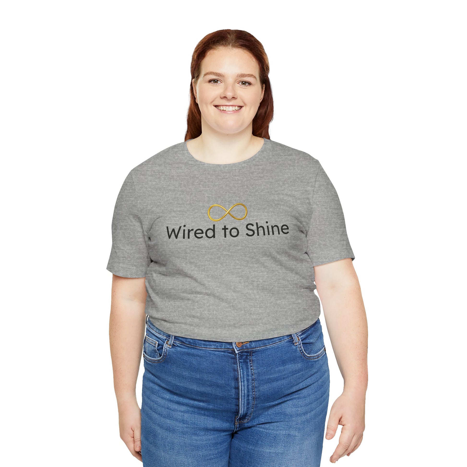 Person wearing a gray t-shirt with 'Wired to Shine' text and infinity symbol on a white background
